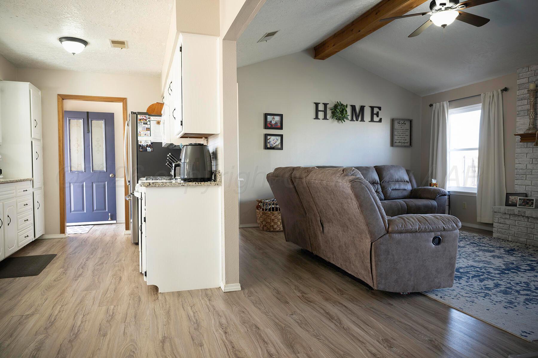 611 Floyd Avenue Dumas, TX 79029 - Photo 7 of 28 a living room with furniture and a flat screen tv