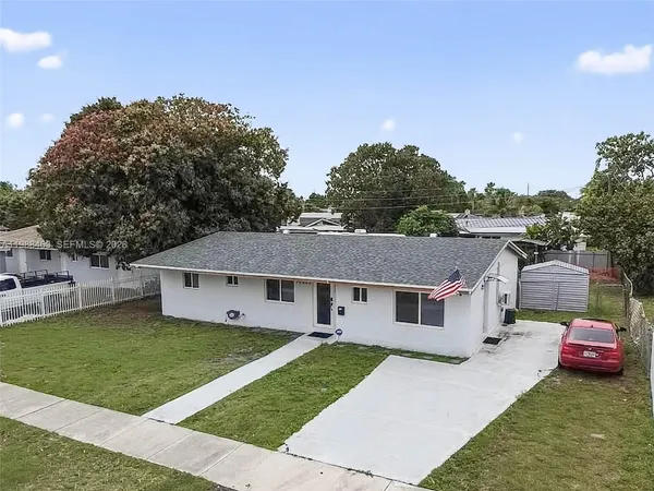 a aerial view of a house with a yard and garage