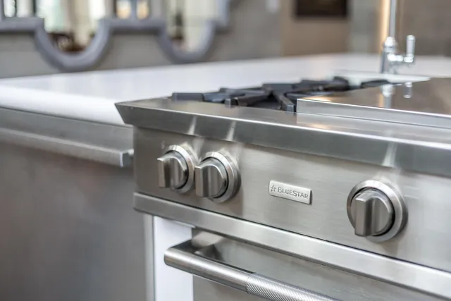 a kitchen with granite countertop a refrigerator and a stove