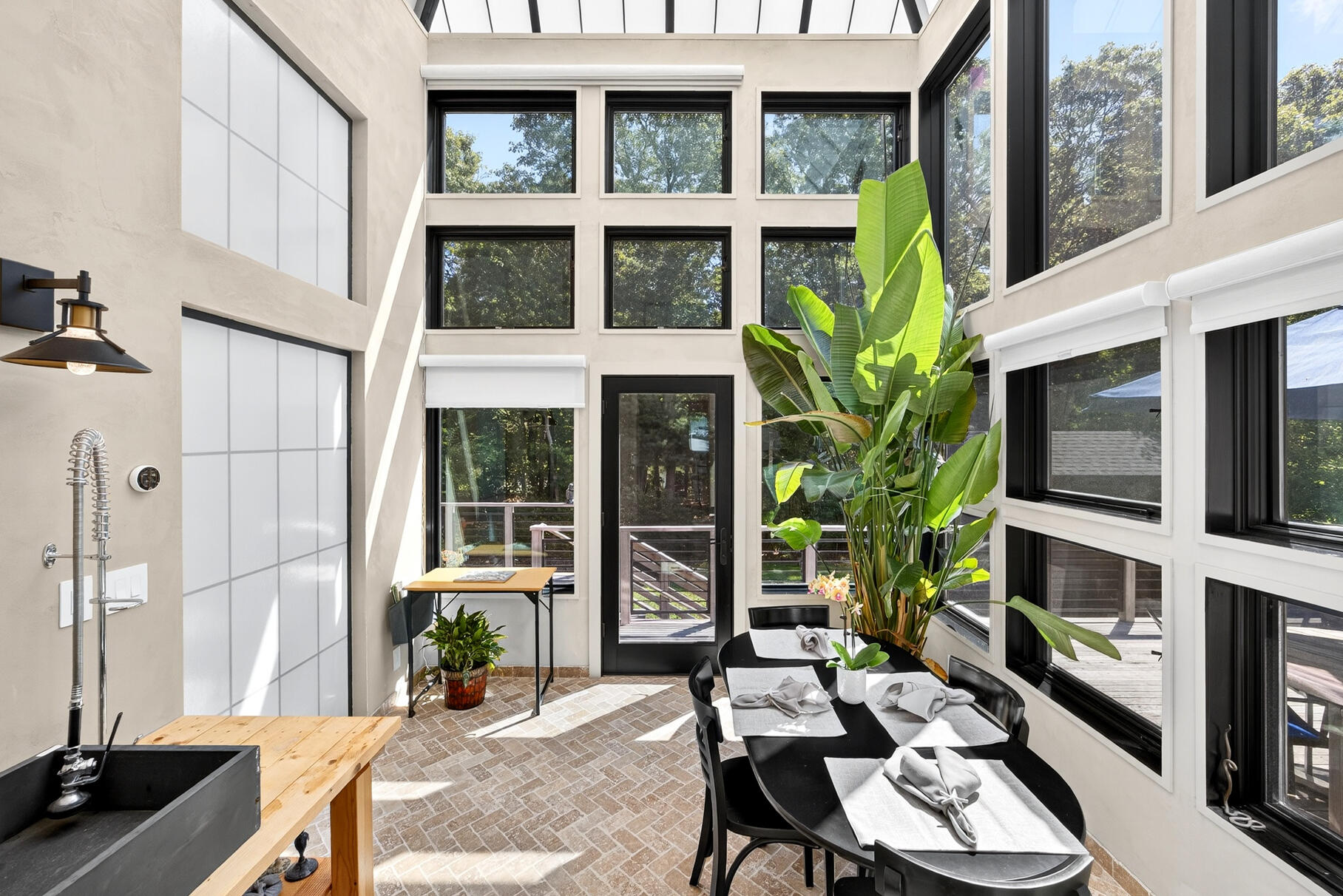 50 Rivers Edge Road East Falmouth, MA 02536 - Photo 15 of 55 a view of a patio with table and chairs potted plants and floor to ceiling window