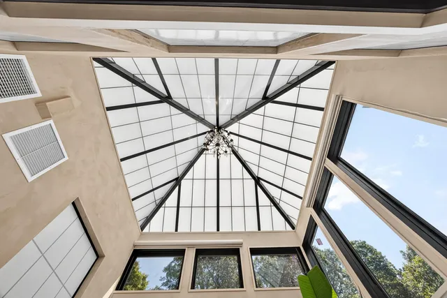 a living room with furniture and large windows