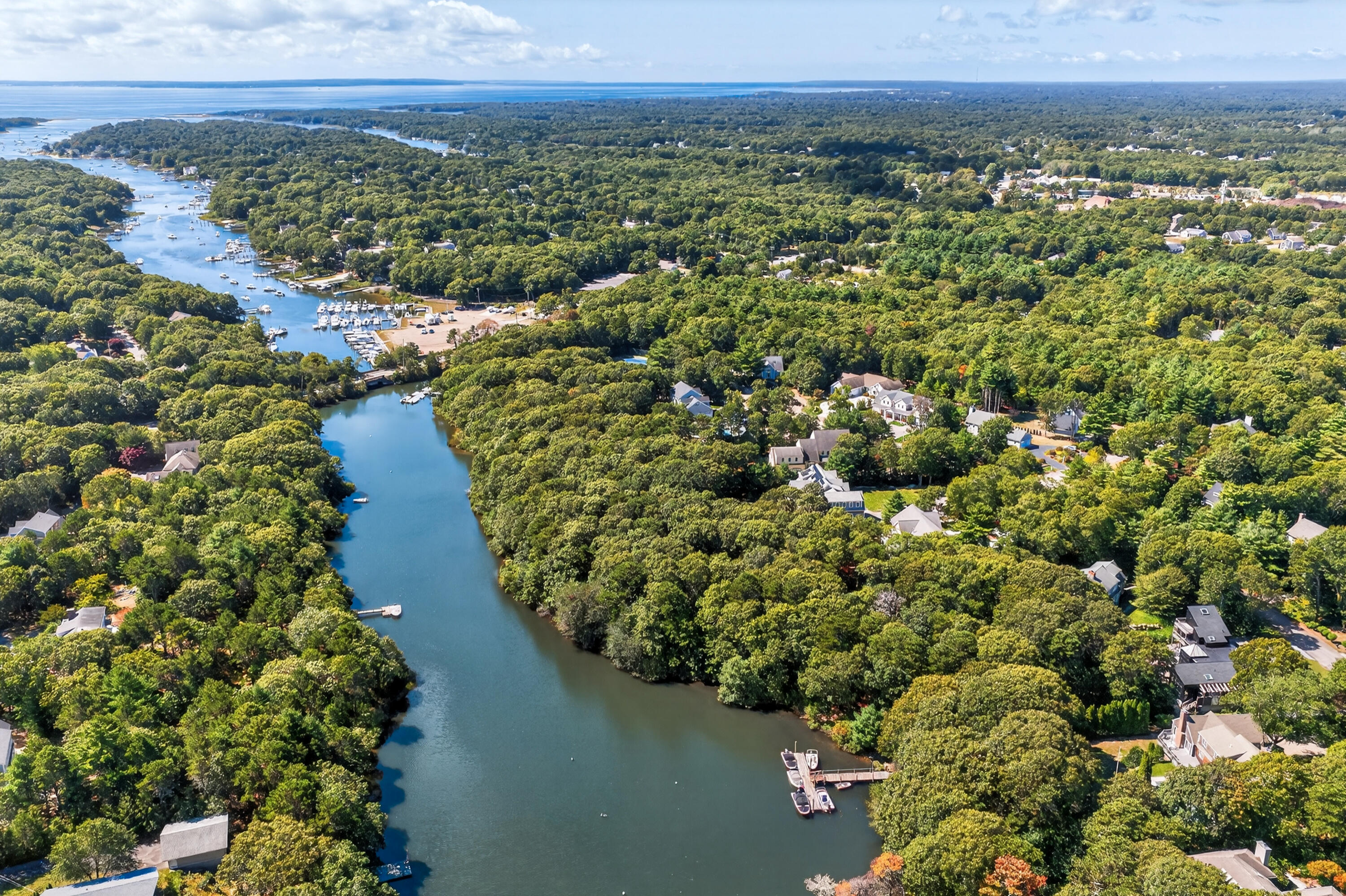 50 Rivers Edge Road East Falmouth, MA 02536 - Photo 2 of 55 a view of a lake with a building in the background