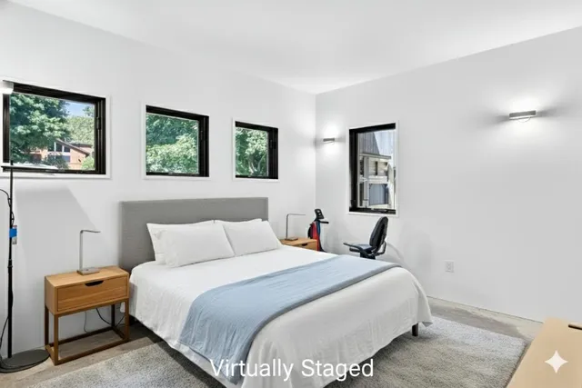 a work room with furniture and large windows