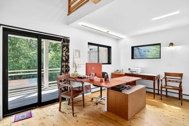 a view of a house with pool and sitting area