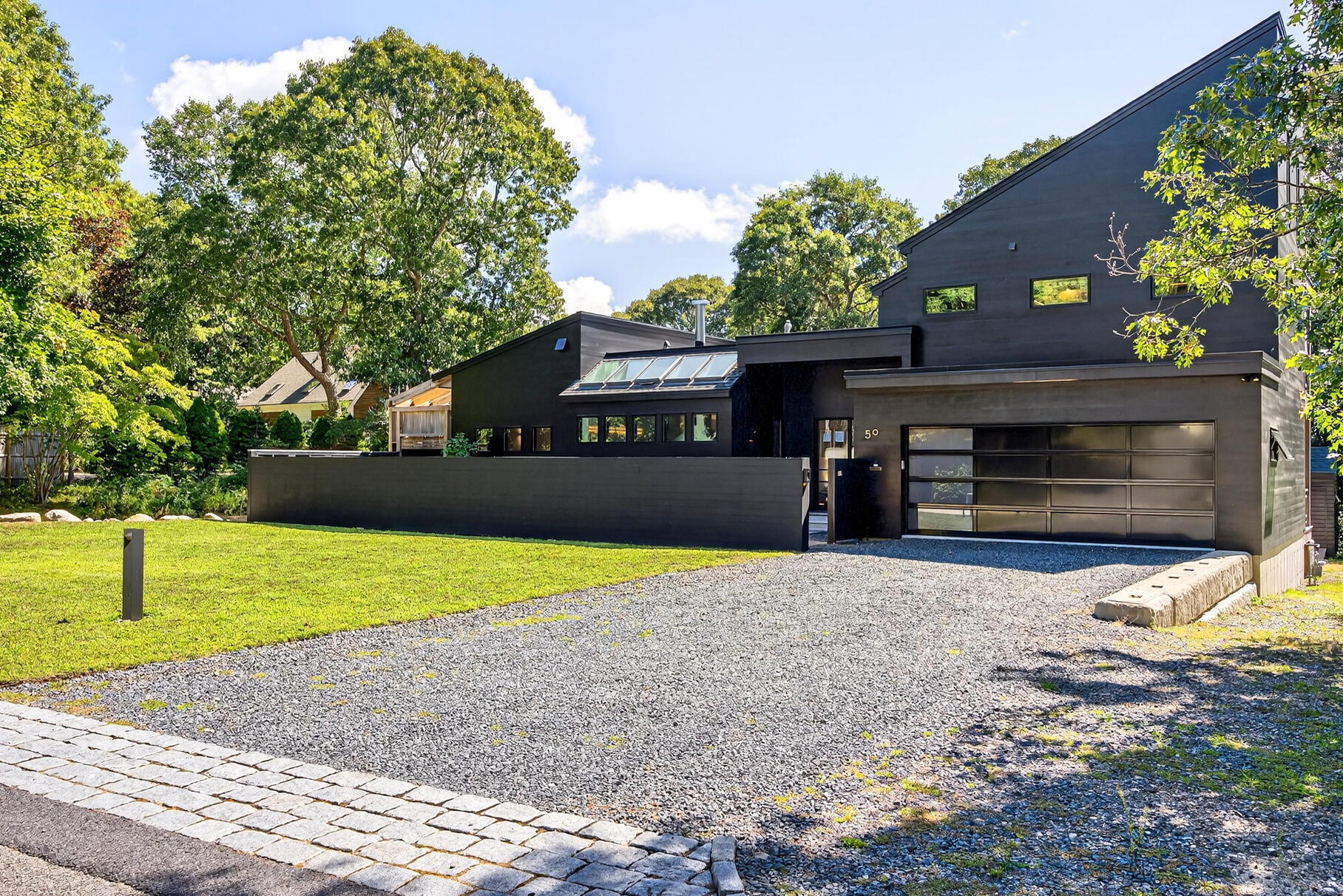 50 Rivers Edge Road East Falmouth, MA 02536 - Photo 46 of 55 a front view of a house with a yard and garage