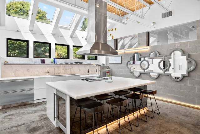 a kitchen with stainless steel appliances granite countertop a sink and a stove