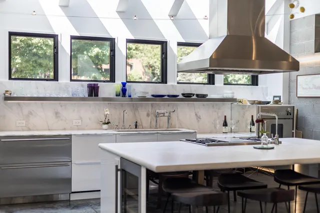 a kitchen with a table chairs stove and cabinets