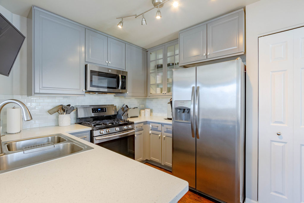 338 Springmist Court Bolingbrook, IL 60440 - Photo 12 of 29 a kitchen with stainless steel appliances granite countertop a refrigerator a sink a stove top oven and a refrigerator