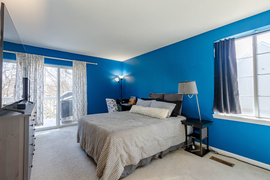 338 Springmist Court Bolingbrook, IL 60440 - Photo 14 of 29 a bedroom with a large bed and a large window
