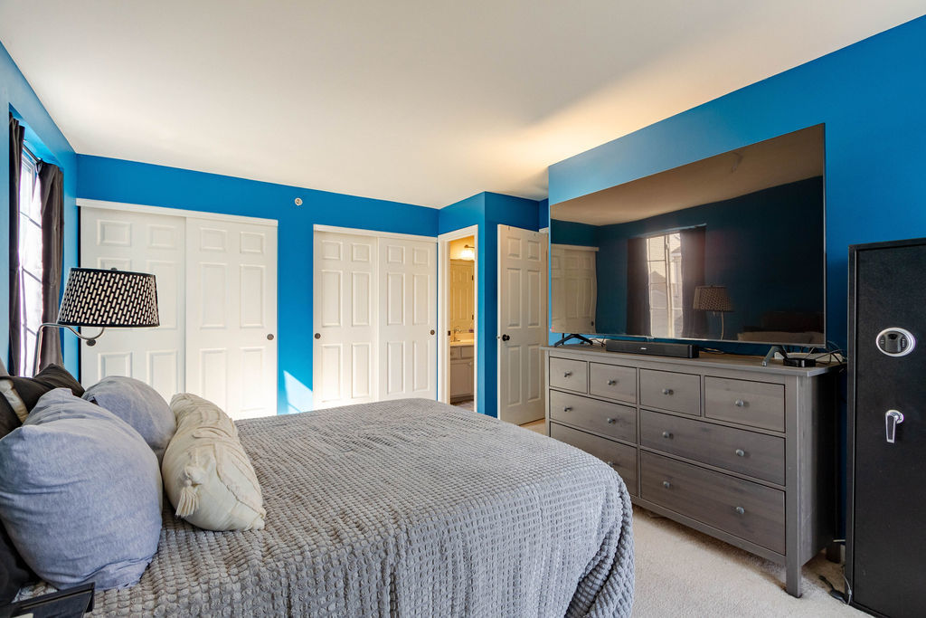 338 Springmist Court Bolingbrook, IL 60440 - Photo 16 of 29 a bedroom with a large bed and a flat screen tv