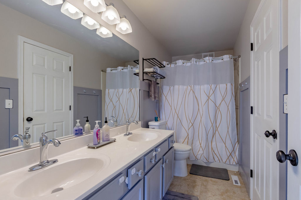 338 Springmist Court Bolingbrook, IL 60440 - Photo 17 of 29 a bathroom with a sink double vanity and a mirror