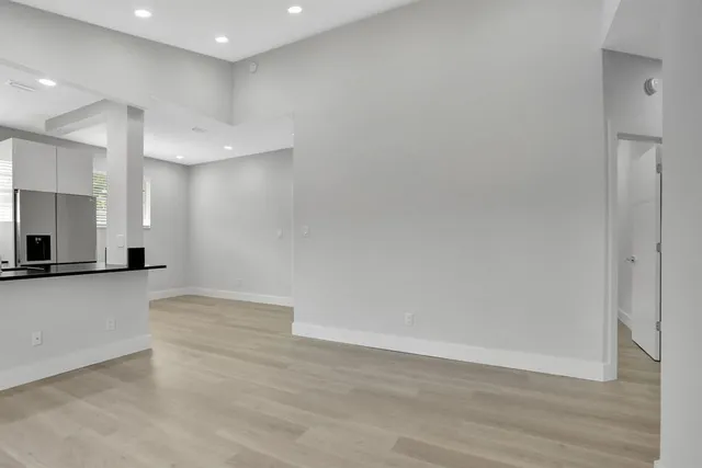 a view of a kitchen with a sink and a large window