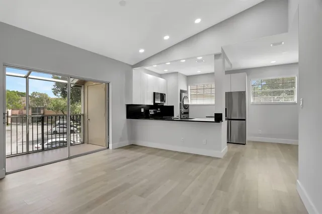 a view of kitchen with stainless steel appliances refrigerator oven