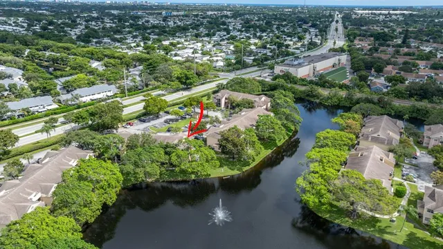an aerial view of a house with a yard and lake view