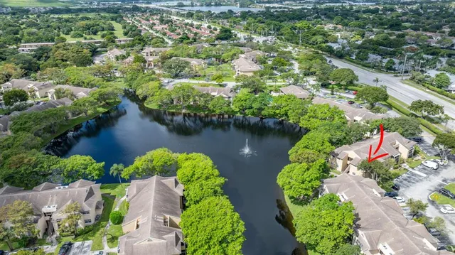an aerial view of a houses with a yard