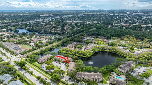 an aerial view of residential houses with outdoor space and trees
