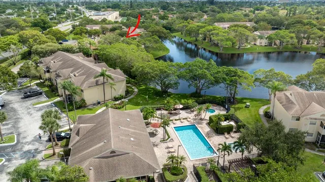 an aerial view of multiple houses with a lake view