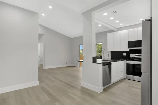 a kitchen with granite countertop a stove and a sink
