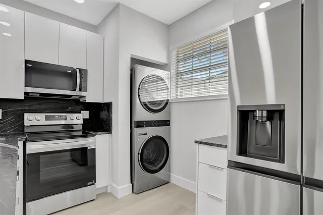 a view of kitchen with a stove top oven microwave and cabinets