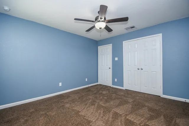 a view of a room with a ceiling fan