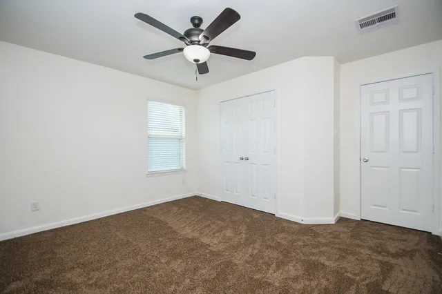 a view of a big room with a ceiling fan