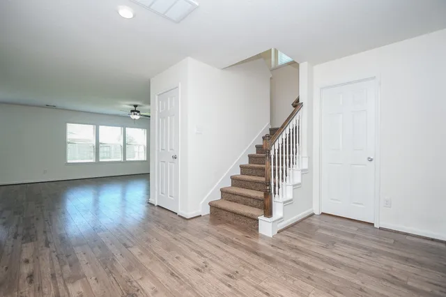 a view of entryway and hall with wooden floor