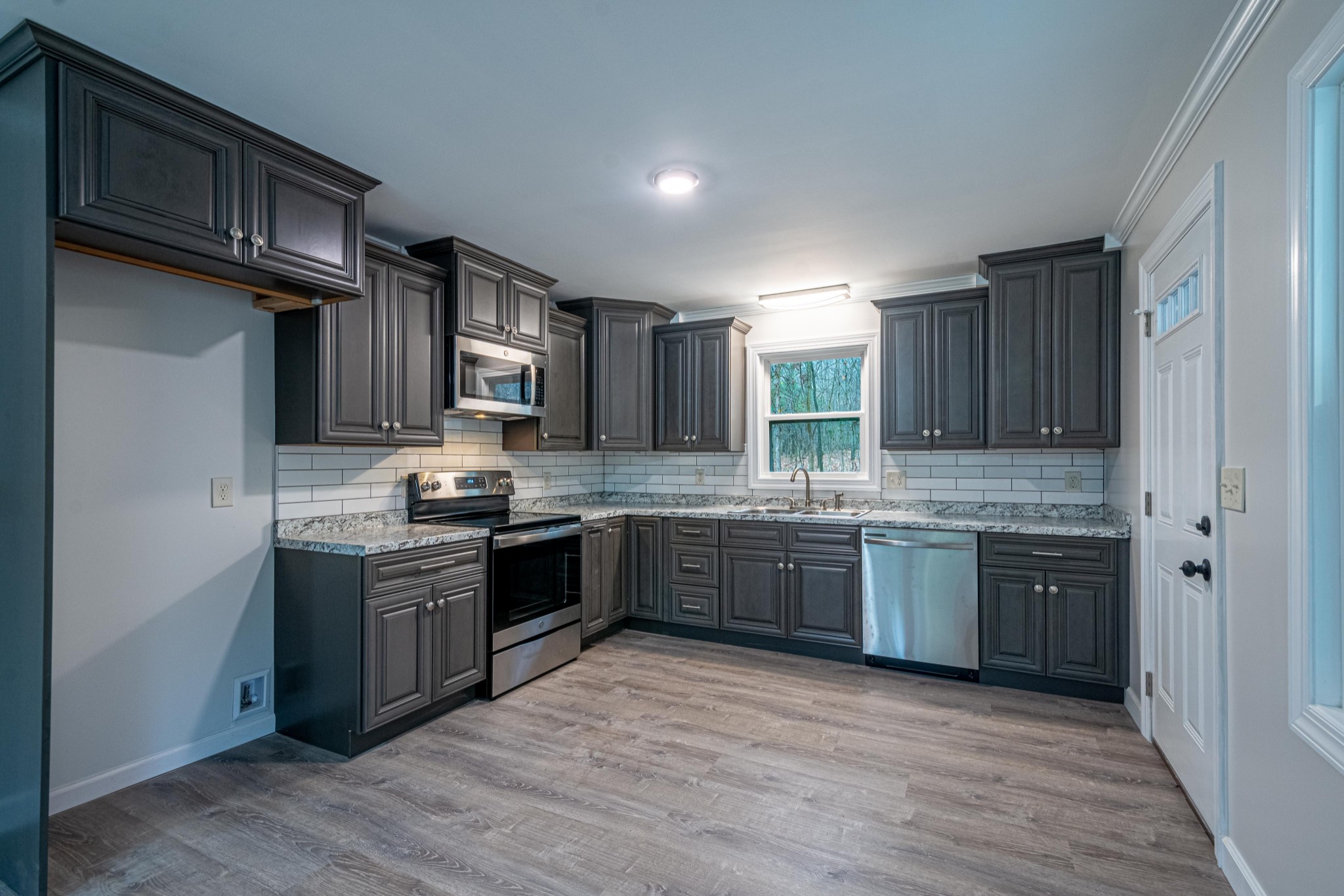 1844 Prospect Elkton Road Prospect, TN 38477 - Photo 5 of 43 a large kitchen with stainless steel appliances granite countertop a stove sink and cabinets
