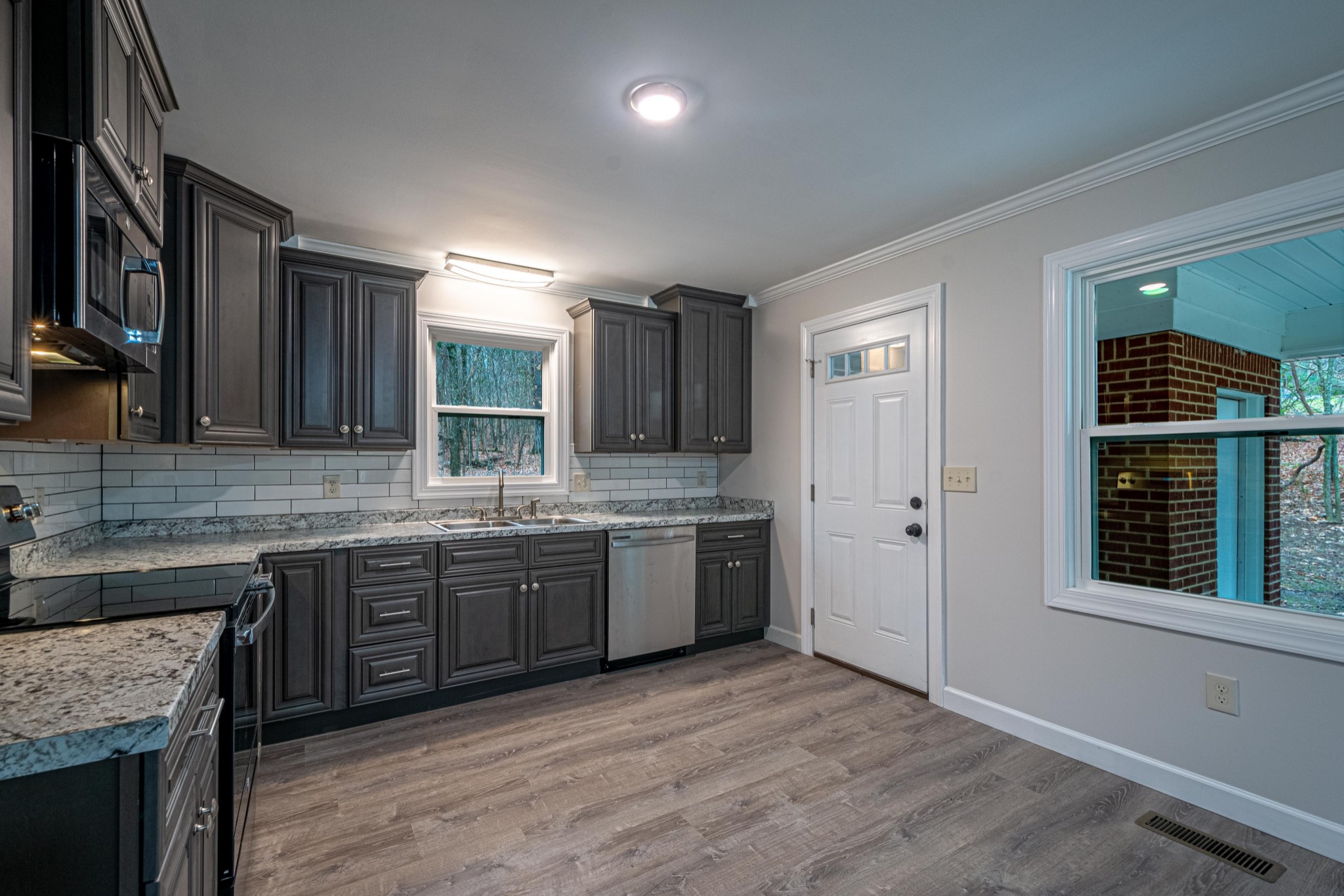 1844 Prospect Elkton Road Prospect, TN 38477 - Photo 6 of 43 a kitchen with granite countertop a sink cabinets and wooden floor