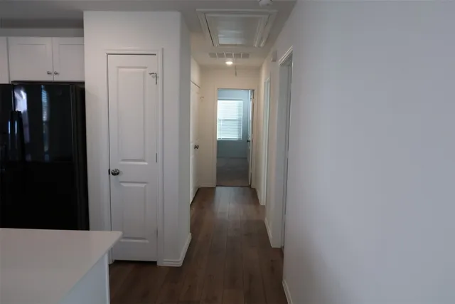 a kitchen with a sink a microwave a refrigerator and cabinets