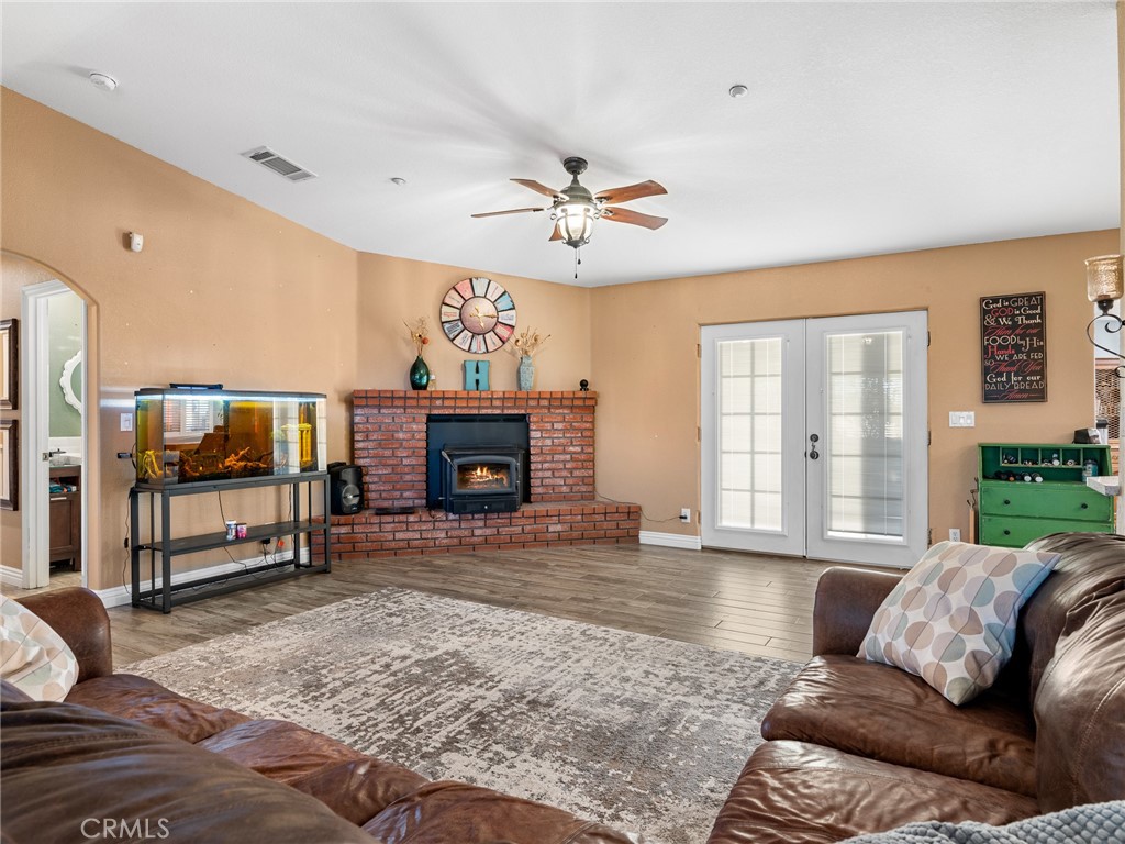 12326 Silver Rock Road Pinon Hills, CA 92372 - Photo 12 of 41 a living room with furniture a fireplace and a flat screen tv