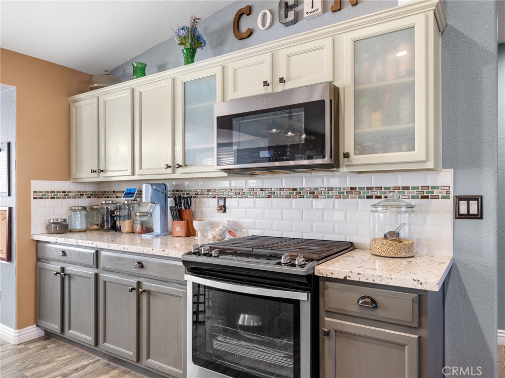 12326 Silver Rock Road Pinon Hills, CA 92372 - Photo 17 of 41 a kitchen with granite countertop a stove sink and cabinets