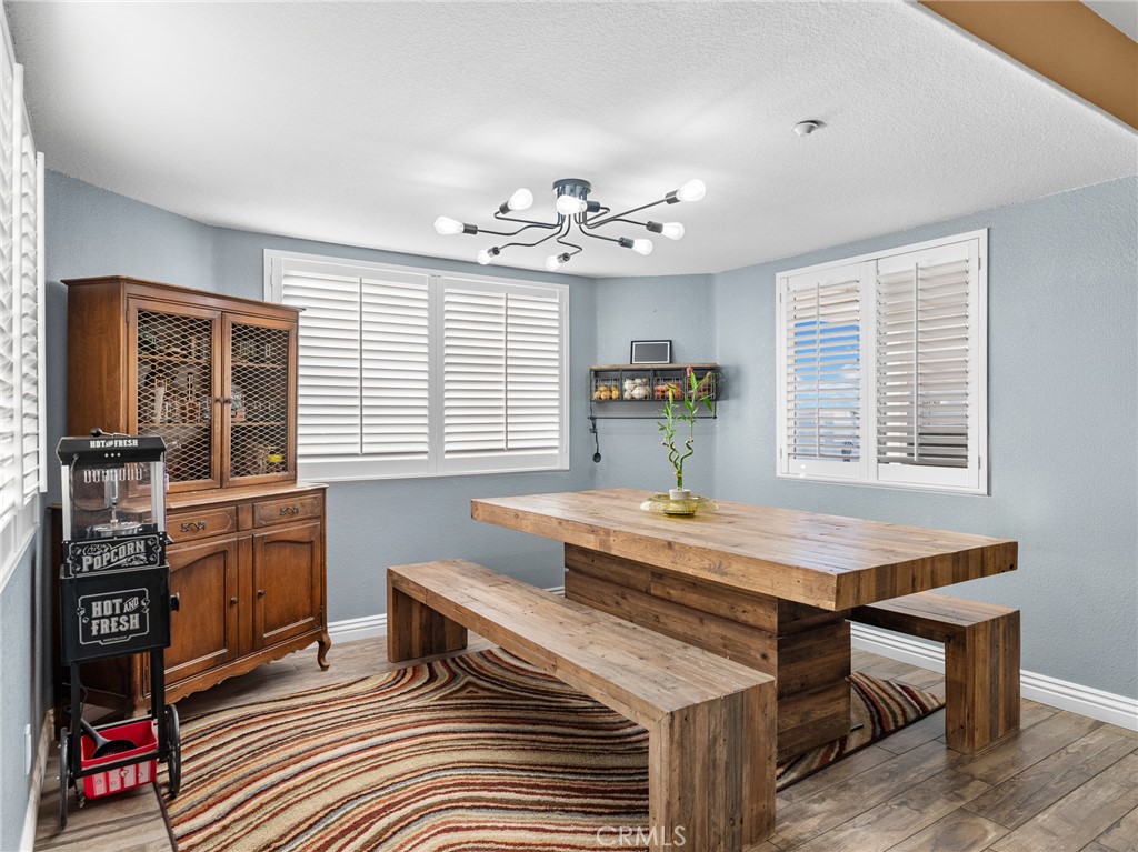 12326 Silver Rock Road Pinon Hills, CA 92372 - Photo 20 of 41 a room with a table chairs and windows
