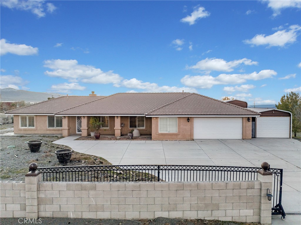 12326 Silver Rock Road Pinon Hills, CA 92372 - Photo 2 of 41 a front view of a house with a fence