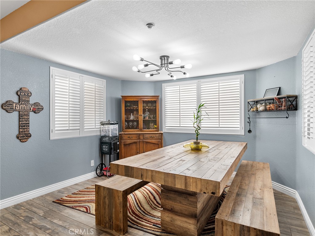 12326 Silver Rock Road Pinon Hills, CA 92372 - Photo 21 of 41 a view of a dining room with furniture window and wooden floor