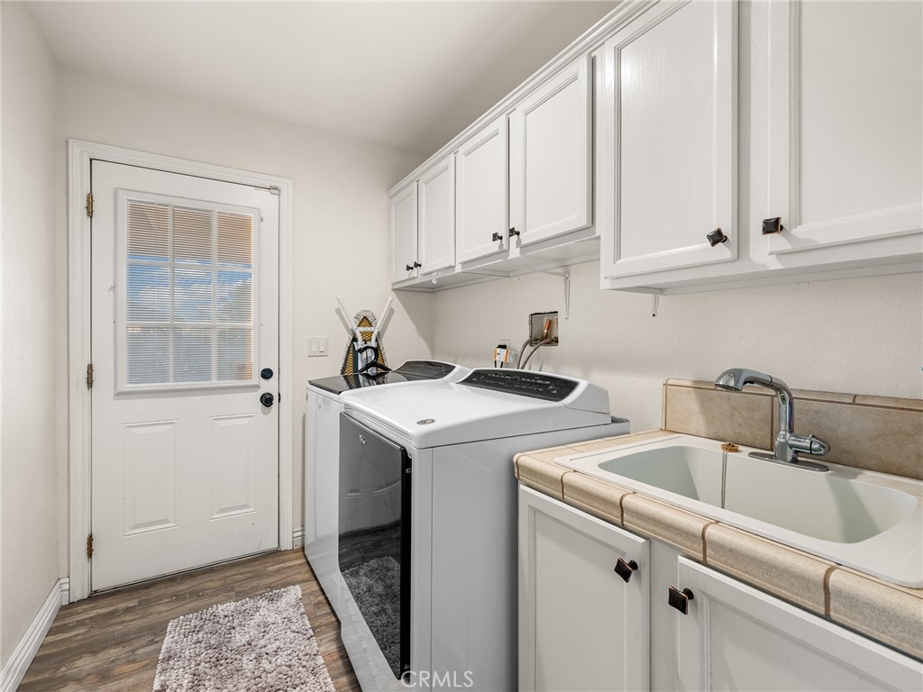12326 Silver Rock Road Pinon Hills, CA 92372 - Photo 22 of 41 a utility room with sink dryer and washer