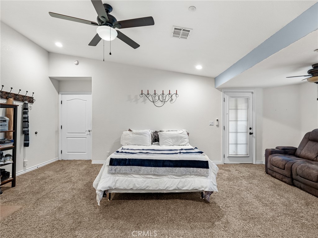 12326 Silver Rock Road Pinon Hills, CA 92372 - Photo 24 of 41 a spacious bedroom with a bed and furniture