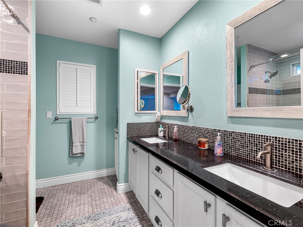 12326 Silver Rock Road Pinon Hills, CA 92372 - Photo 26 of 41 a bathroom with a granite countertop sink a shower and a mirror