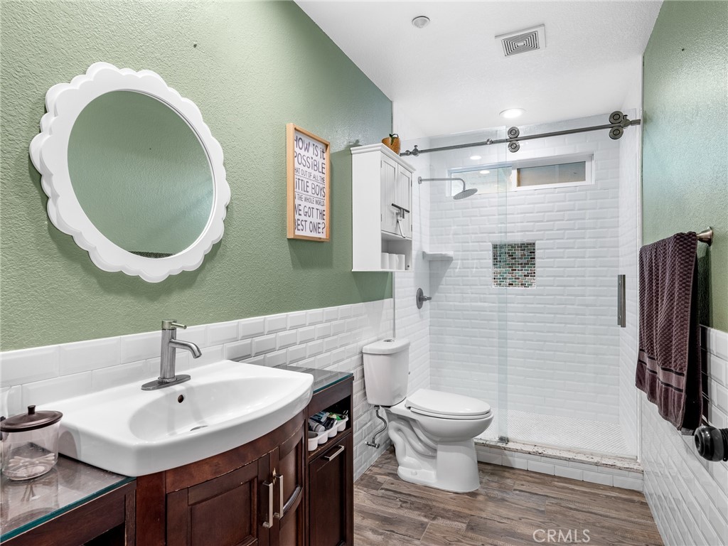 12326 Silver Rock Road Pinon Hills, CA 92372 - Photo 28 of 41 a bathroom with a sink toilet and a mirror