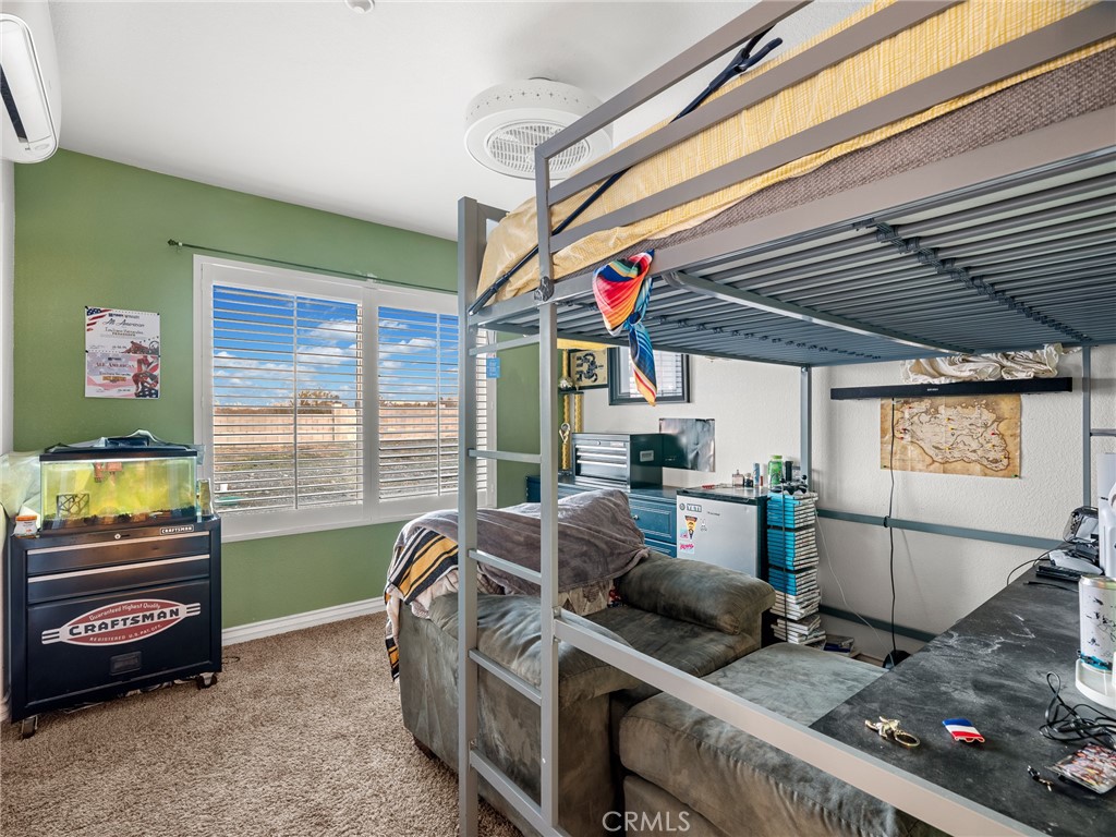 12326 Silver Rock Road Pinon Hills, CA 92372 - Photo 30 of 41 a living room with furniture and a flat screen tv