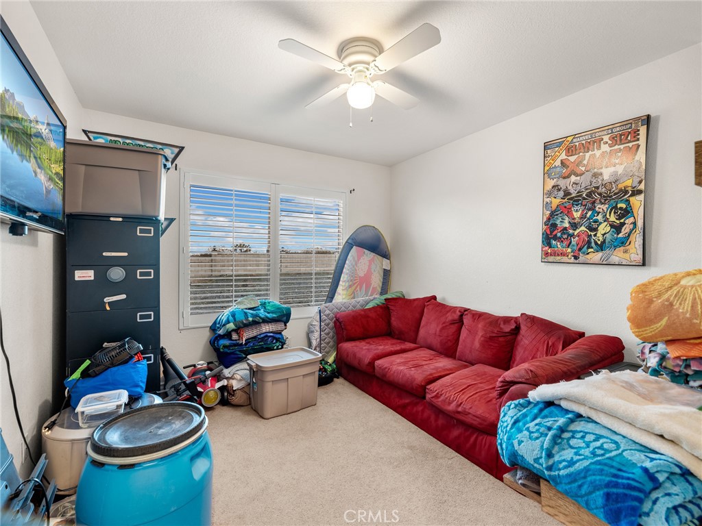 12326 Silver Rock Road Pinon Hills, CA 92372 - Photo 31 of 41 a living room with furniture a rug and a window