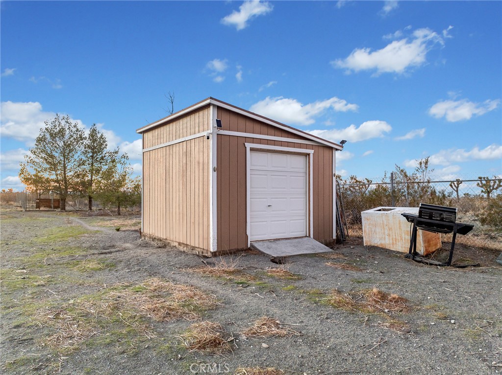 12326 Silver Rock Road Pinon Hills, CA 92372 - Photo 36 of 41 a view of a house with backyard and a tree
