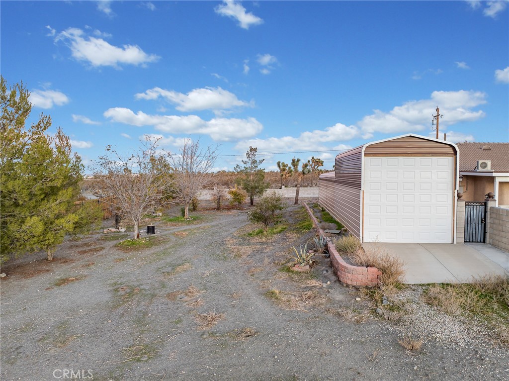 12326 Silver Rock Road Pinon Hills, CA 92372 - Photo 5 of 41 a view of a dry yard with wooden fence