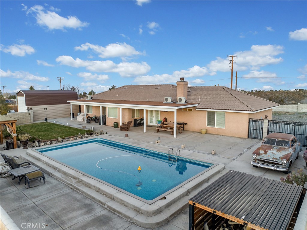 12326 Silver Rock Road Pinon Hills, CA 92372 - Photo 7 of 41 a view of a house with pool and chairs