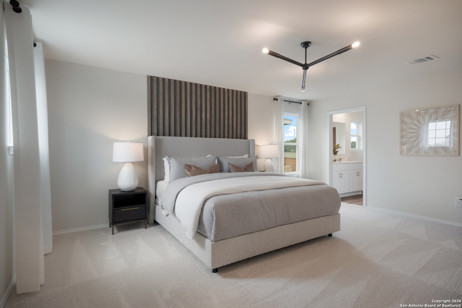 4059 Paddock Trail Seguin, TX 78155 - Photo 23 of 29 a bedroom with a bed and a chandelier