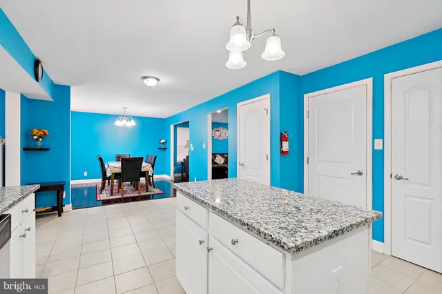 a view of kitchen with sink refrigerator and dining area