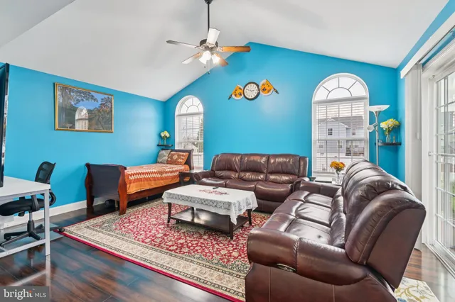 a living room with furniture a rug and a window