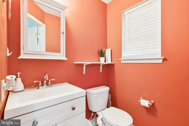 a bathroom with a sink mirror and toilet