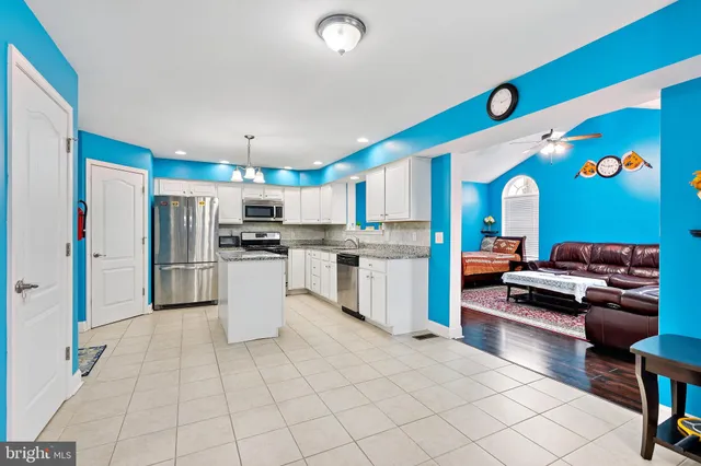 a kitchen with stainless steel appliances granite countertop a refrigerator and a stove top oven
