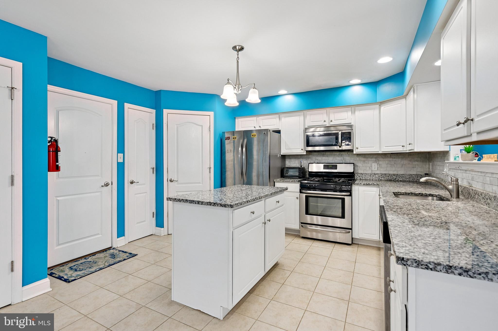26 North Poplar Avenue Maple Shade, NJ 08052 - Photo 9 of 26 a kitchen with stainless steel appliances granite countertop a stove sink and cabinets