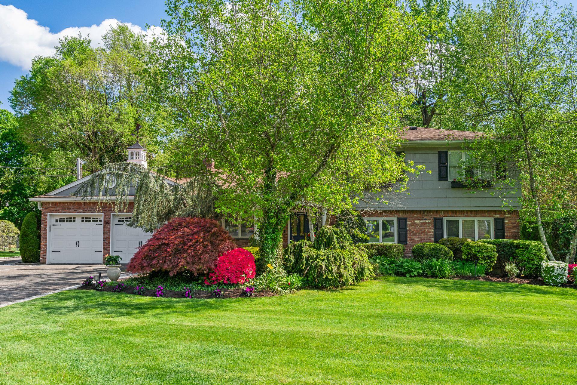 a front view of a house with a garden